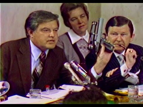 Frank Church holds a CIA-designed “heart attack gun” that fired an untraceable poisoned dart of shellfish toxins, for undetected assassination. Image: “Church Committee: 40 Years Later” on C-SPAN3’s Reel America, 2016.